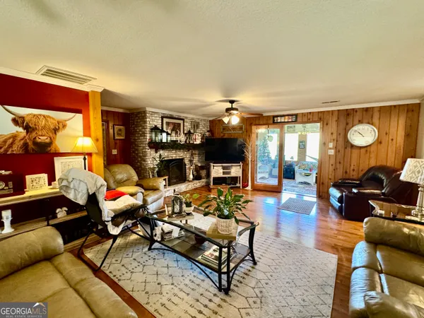 a living room with furniture a rug and a large window
