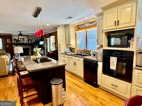 a kitchen that has a stove and a microwave