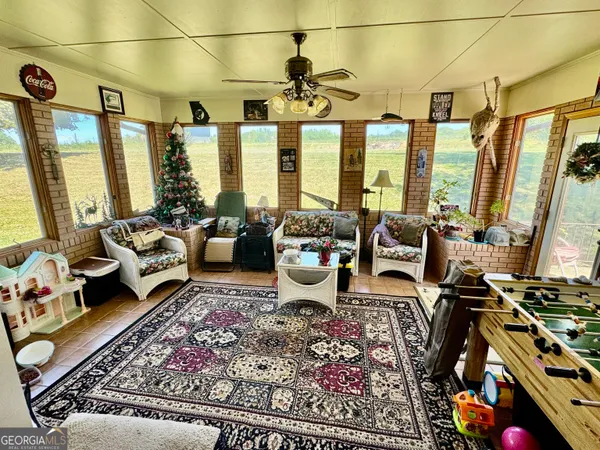 a living room with furniture and large windows