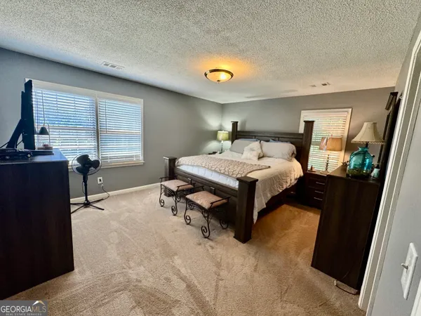 a bedroom with a bed and window