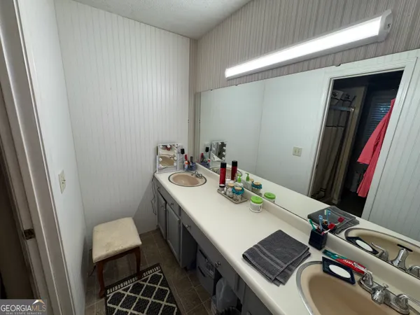 a bathroom with a sink toilet and a mirror