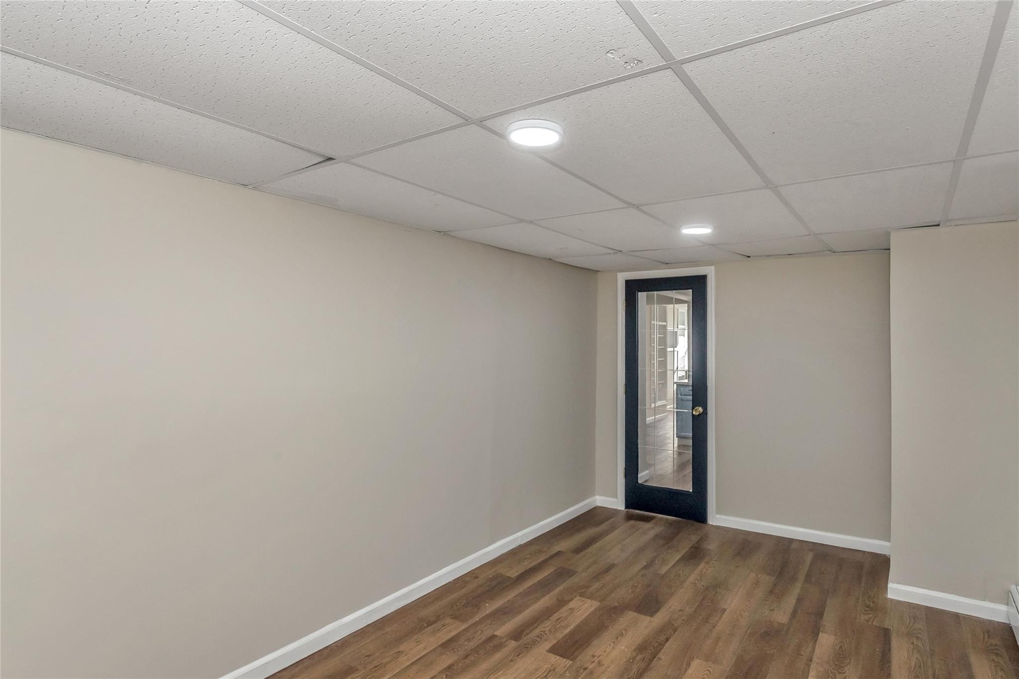 9 Bayberry Road Wading River, NY 11792 - Photo 15 of 17 Spare room with a paneled ceiling and dark wood-type flooring
