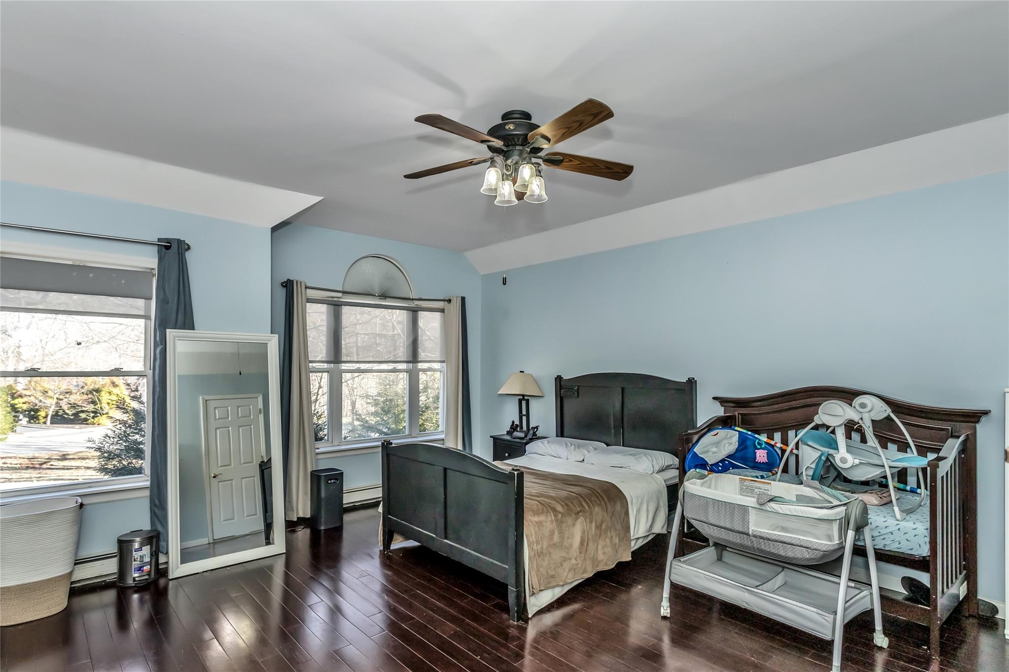 9 Bayberry Road Wading River, NY 11792 - Photo 8 of 17 Bedroom with lofted ceiling, multiple windows, ceiling fan, and dark hardwood / wood-style floors