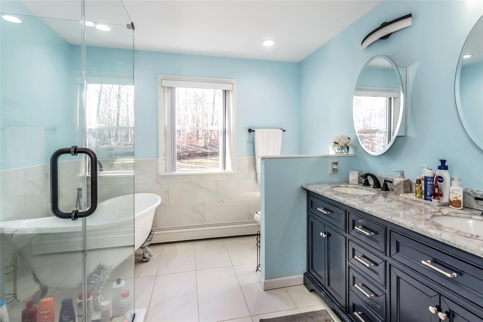 9 Bayberry Road Wading River, NY 11792 - Photo 9 of 17 Bathroom featuring toilet, a tub to relax in, a baseboard heating unit, tile patterned floors, and vanity
