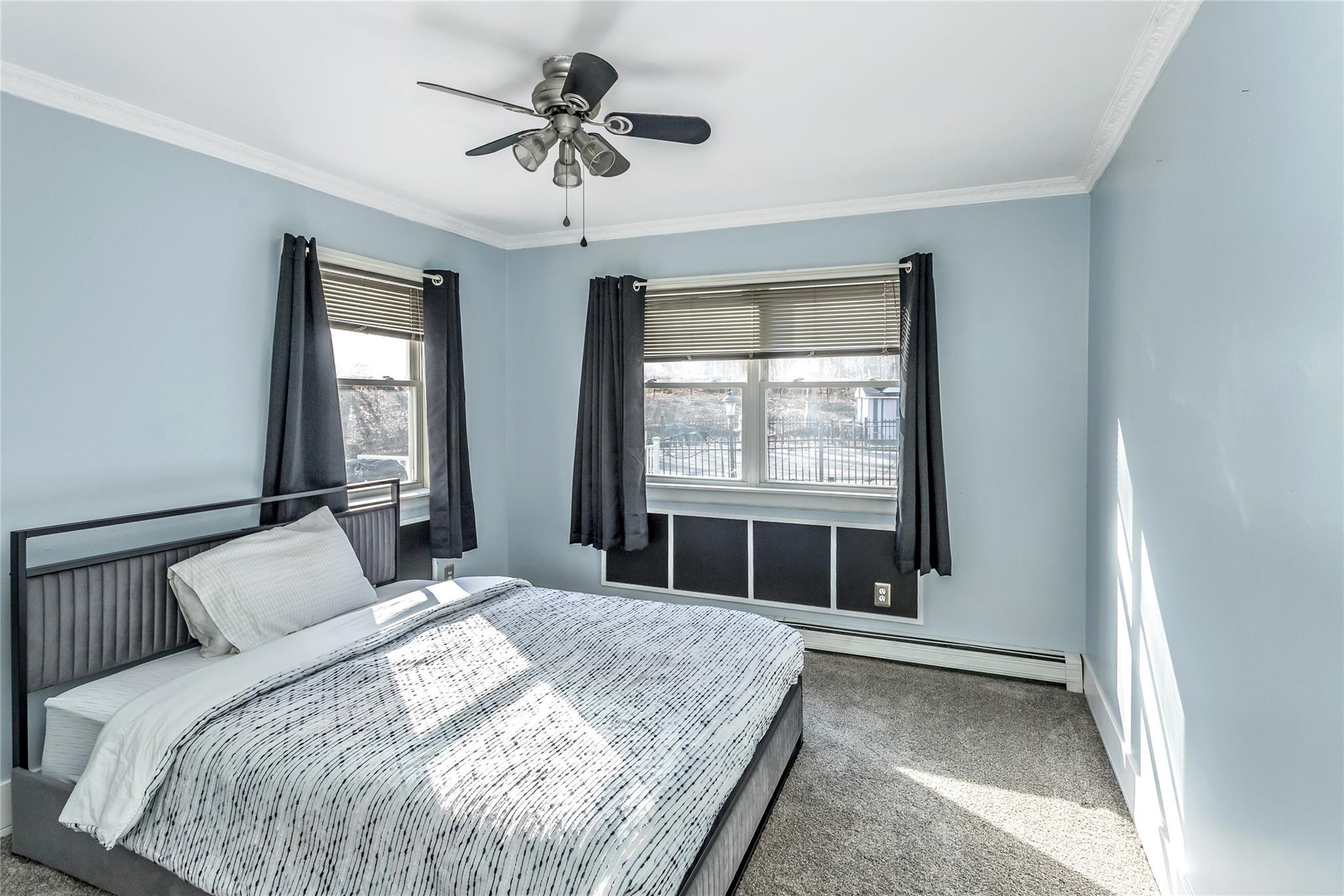 9 Bayberry Road Wading River, NY 11792 - Photo 10 of 17 Carpeted bedroom featuring ceiling fan, ornamental molding, and a baseboard radiator
