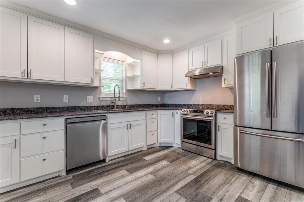 606 Ridgeline Drive Hurst, TX 76053 - Photo 1 of 29 a kitchen with granite countertop white cabinets stainless steel appliances and a window