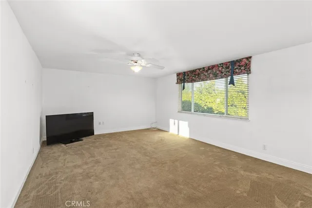 a view of a chair and table in backyard of the house