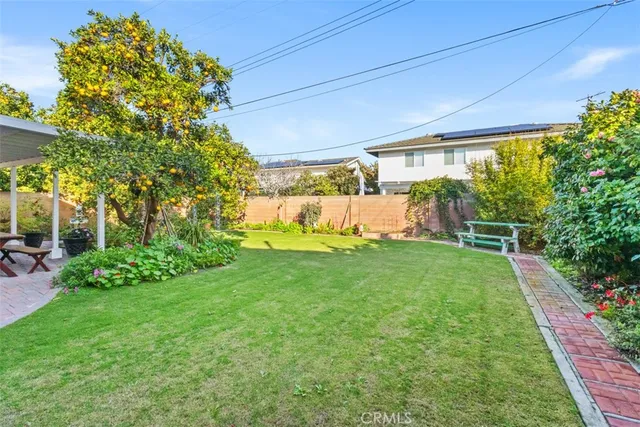 a patio with table and chairs and potted plants