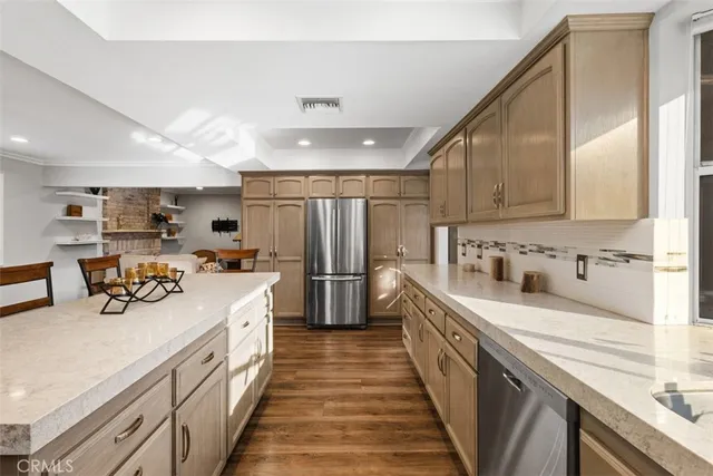 a kitchen with stainless steel appliances a sink stove top oven and cabinets