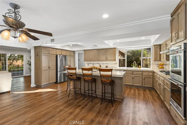 a kitchen with lots of counter top space and stainless steel appliances