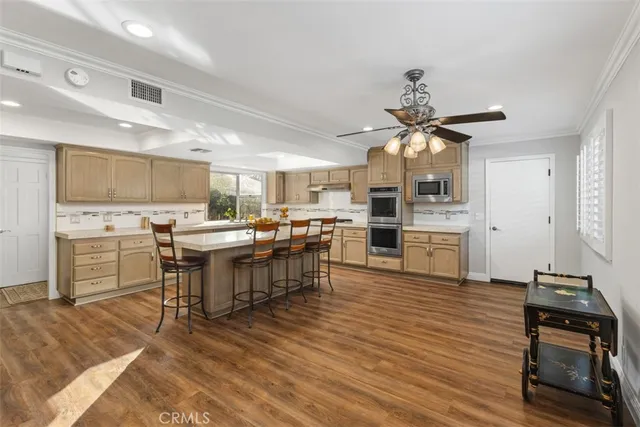 a kitchen with a sink appliances and cabinets