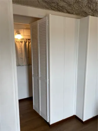 a view of a hallway with wooden floor