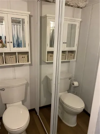 a white toilet sitting next to a bathroom sink