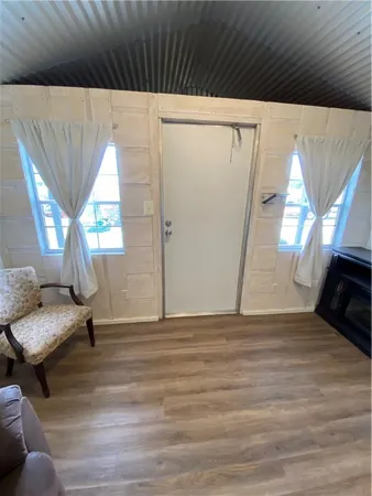 a view of a livingroom with furniture and a window