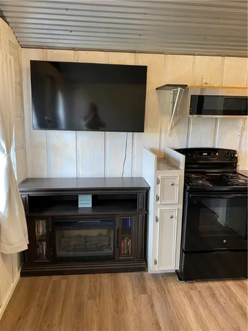 a kitchen with granite countertop a stove and a microwave