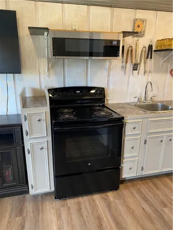 a kitchen with a stove and a microwave