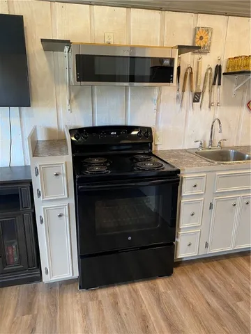 a kitchen with a stove and a microwave
