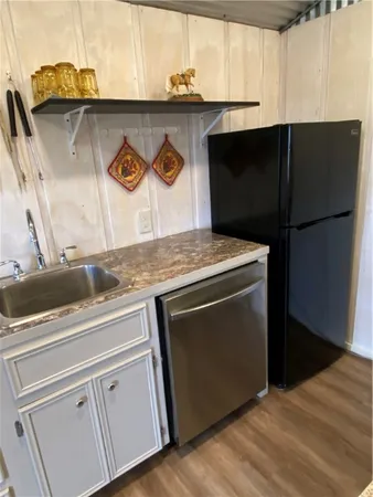 a kitchen with a sink and a refrigerator