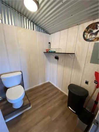 a bathroom with a toilet and a shower