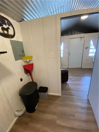 a view of empty room with wooden floor