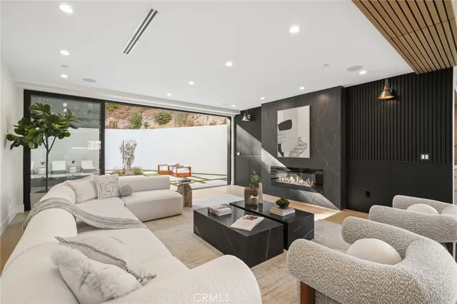 a large white kitchen with a large window and stainless steel appliances