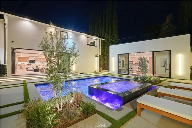 a living room with pool table and a large window