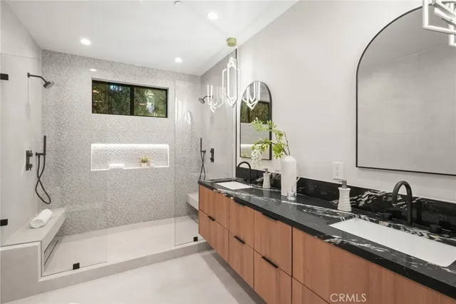 a spacious bathroom with double sink and a mirror
