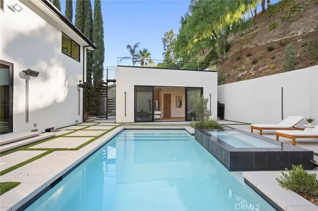 a bedroom with a bed and a refrigerator