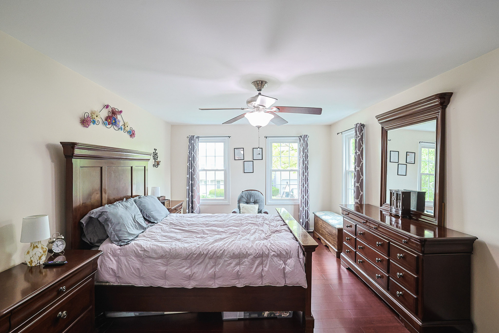830 Hawk Lane Carol Stream, IL 60188 - Photo 14 of 30 a spacious bedroom with a bed and wooden floor