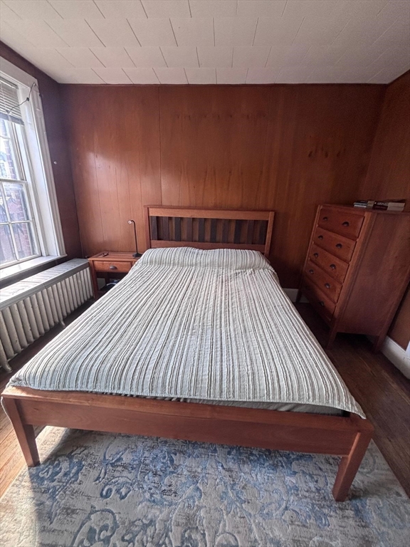 85 Phillips Street, Unit 7 Boston, MA 02114 - Photo 4 of 5 a bed sitting in a bedroom next to a window with rug