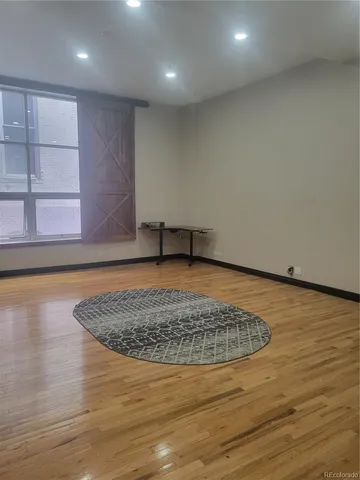 a view of a room with wooden floor