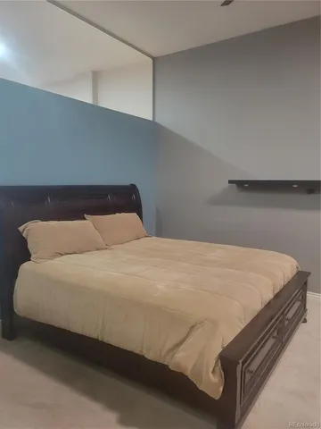 a bedroom with a bed and pillows