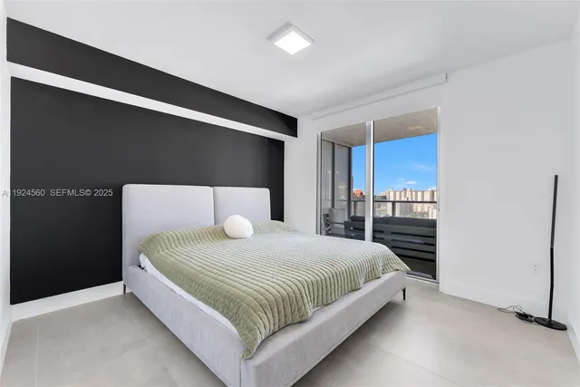 a bedroom with a bed and a large mirror