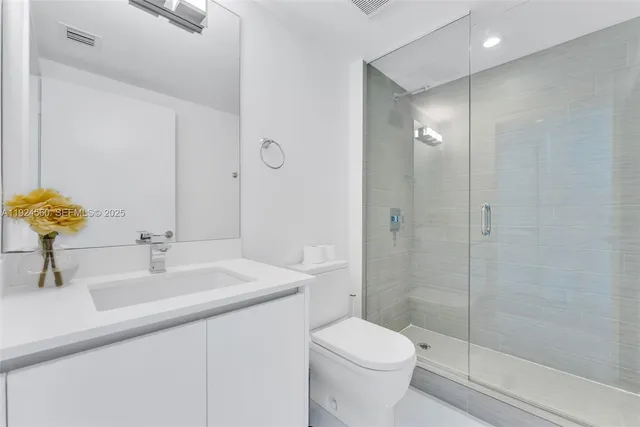 a bathroom with a sink toilet and shower