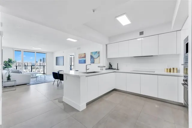 a kitchen with white cabinets and white appliances