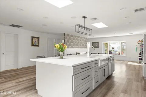 a kitchen with a sink and a stove top oven