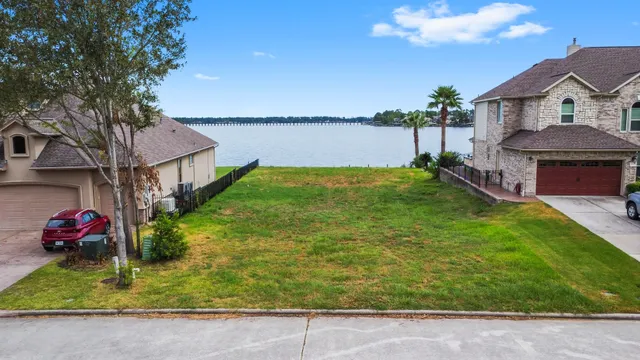 a view of a house with a big yard and large trees