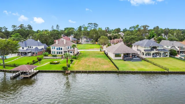 a view of a swimming pool with lawn chairs and a yard