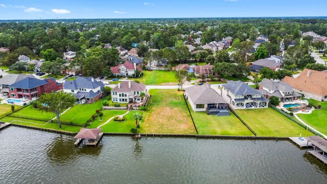 an aerial view of a tennis ground and a cars park side of a road