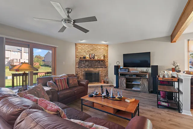 a living room with fireplace furniture and a flat screen tv