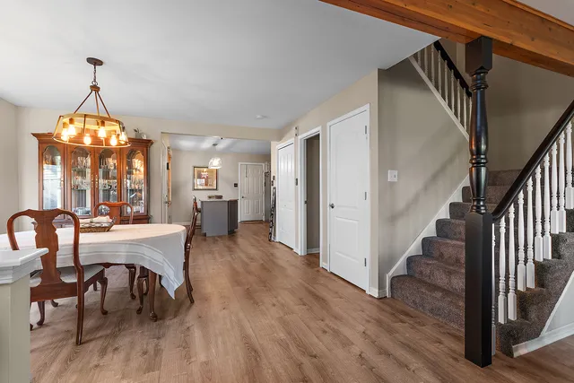 a view of a a dining room with furniture window and wooden floor