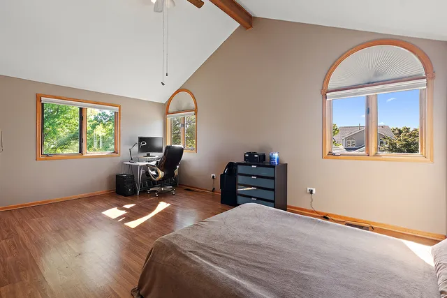 a bed room with a bed and a large window