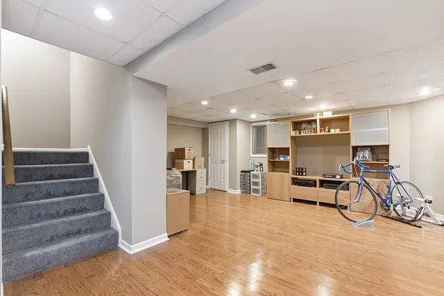 a view of a room with chairs and stairs