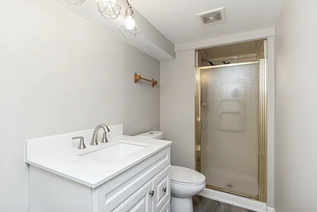 a bathroom with a sink toilet and shower