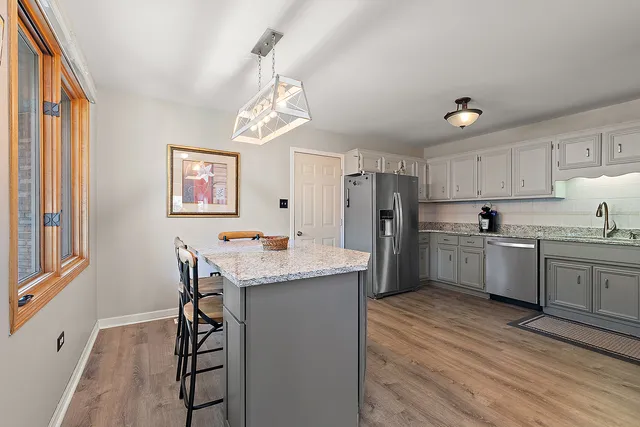a kitchen with refrigerator cabinets and wooden floor