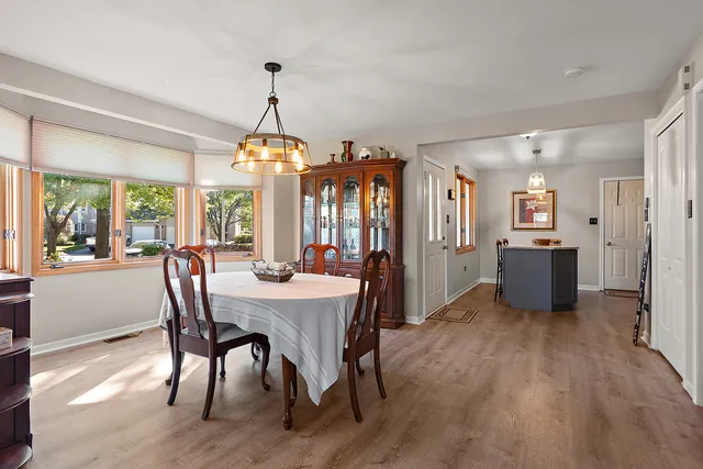 a view of a dining room with furniture window and wooden floor