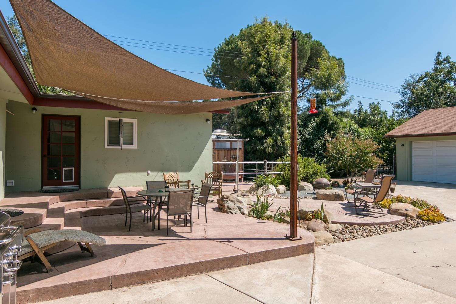 750 South Rice Road Ojai, CA 93023 - Photo 21 of 27 a view of a patio with table and chairs potted plants and a palm tree