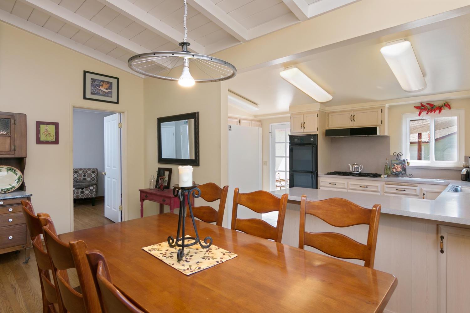 750 South Rice Road Ojai, CA 93023 - Photo 7 of 27 a living room with dining table and a chandelier