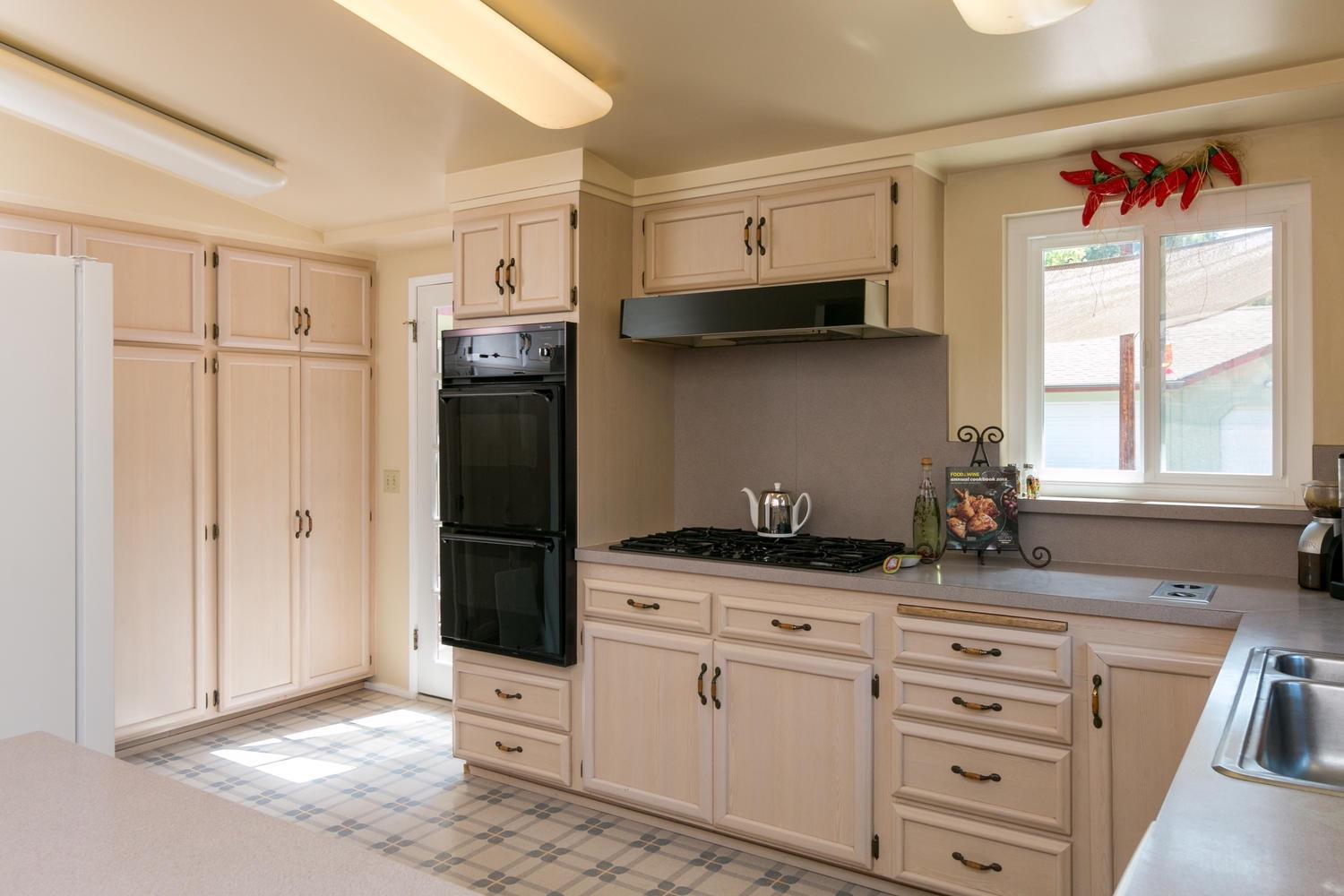 750 South Rice Road Ojai, CA 93023 - Photo 9 of 27 a kitchen with white cabinets and window