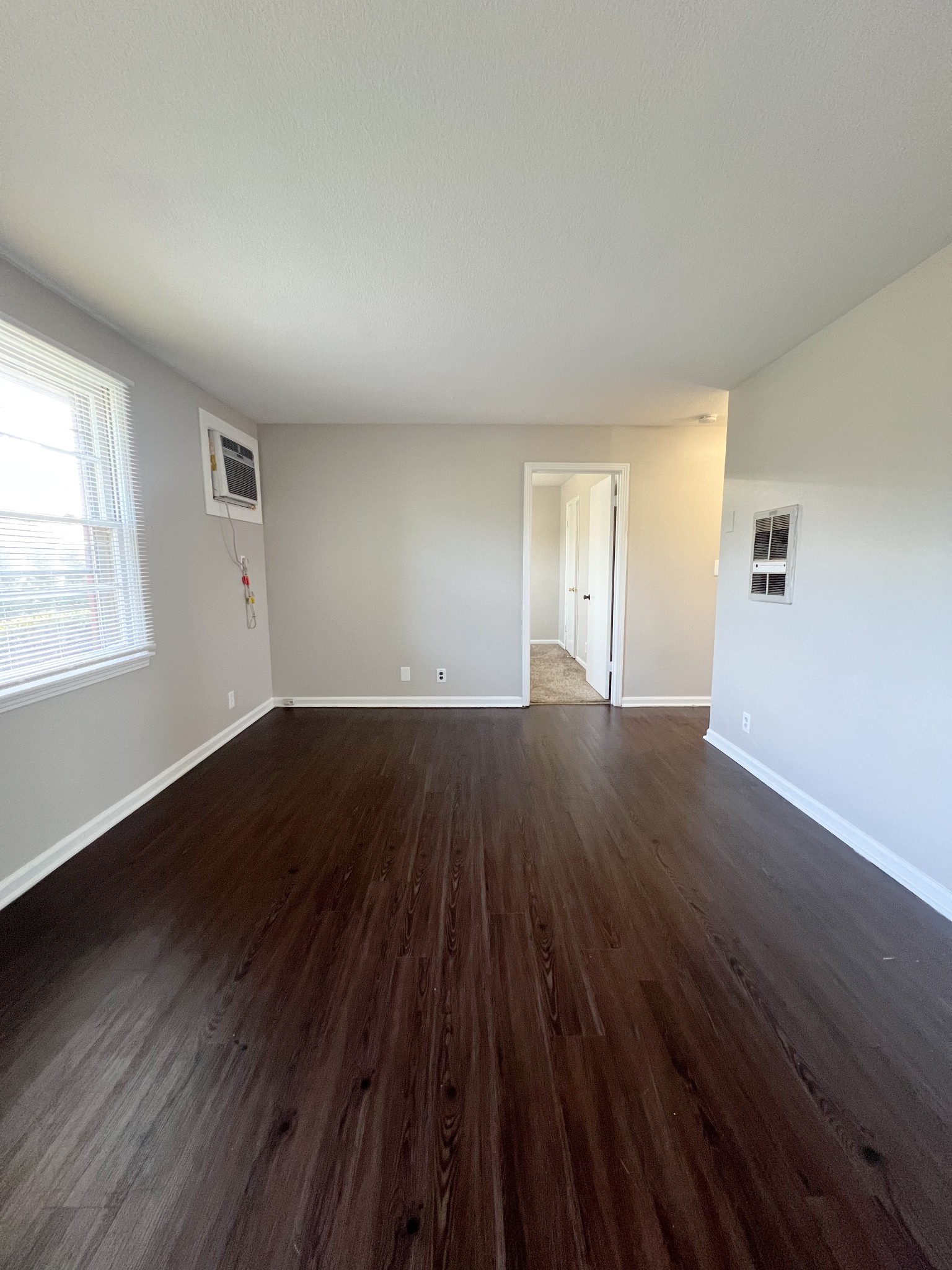 135 Airport Road, Unit C Clarksville, TN 37042 - Photo 4 of 16 an empty room with wooden floor and windows